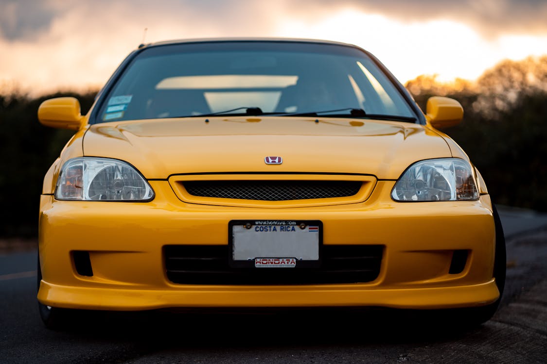 Yellow Honda Civic economy car at sunset
